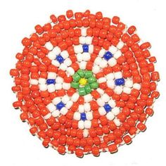 an orange, white and blue beaded brooch