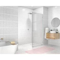 a bathroom with white tiles and a pink rug in front of the bathtub is shown