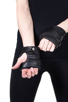 KROSS WRAP KOMBAT Black Fingerless Leather Gloves Inspired by my days spent as a youth wrapping my hands before boxing, these gloves are super soft padded with an outer band strap that wraps continuously around the entire hand and snaps in place at the wrist. Padded palm and knuckle areas, with a multidimensional texture on the top. These innovative and utilitarian tech wear gloves seamlessly combine old school and new school. To see these gloves in action, check out this video: https://youtu.be Sci Fi Jacket, Fingerless Leather Gloves, Cara Dune, Arm Wear, Tech Wear, Gala Outfit, Fashion Gloves, Driving Gloves, My Days