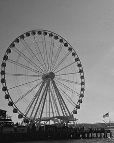 a large ferris wheel sitting on top of a pier