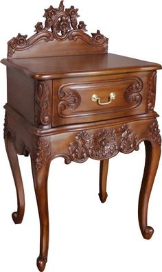 an ornate wooden table with drawers on it