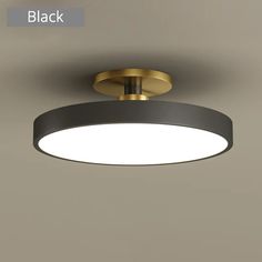 an image of a modern ceiling light with black and gold trim on the bottom half