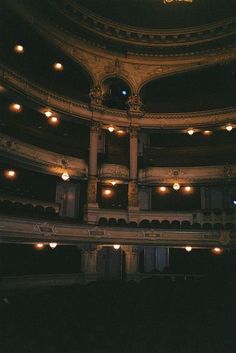 the interior of an old theater with lights on