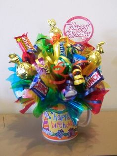 a mug filled with lots of candy and candies