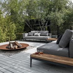 a living room with couches and tables in the middle of an outdoor patio area