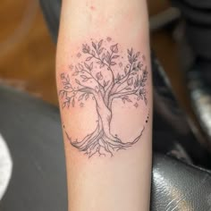 a small tree tattoo on the arm