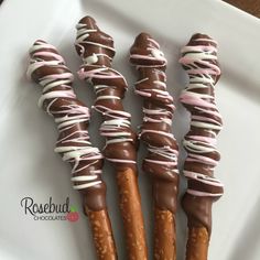 chocolate covered pretzels wrapped in pink and white icing