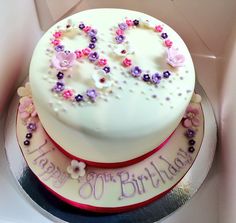 a birthday cake decorated with flowers and the number 50 on it's bottom tier