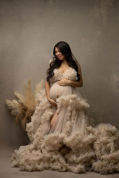 a pregnant woman in a dress made out of feathers