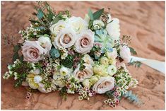 a bridal bouquet is laying on the ground