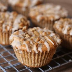 muffins cooling on a wire rack with apples in the backgroung