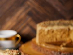 a piece of cake sitting on top of a table next to a cup and saucer