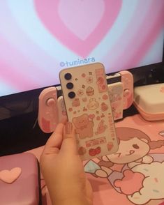 someone is holding up a cell phone case with hello kitty stickers on it