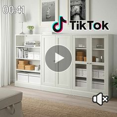 a living room with white furniture and pictures on the wall above it that says tiktok