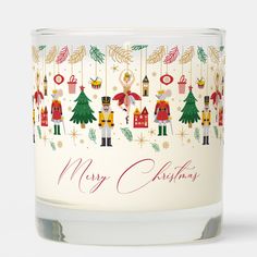 a glass candle with christmas decorations on it