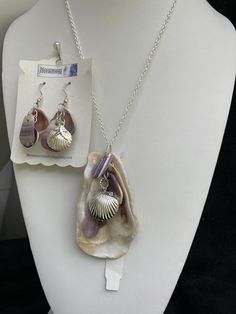 "Natural sea shell pendant necklace, ocean shells clustered with all different types of shells finished with a Sterling plated Sea shell locket pendant with matching earrings with Sterling plated shells also. Includes Sterling plated earring hoops.  On a Sterling silver plated 20\" cable chain. Unique seashell pendant measures 3 1/4\" X 1 3/4'' Earrings are 2 1/8 from the lob part of the hook.  You can compare the size of the shells to the $0.50 cent piece in the pictures. All my necklaces are d Silver Shell Necklace For Gift, Ocean-inspired Charms For Jewelry Making, Silver Shell Pendant Jewelry, Silver Shell With Pearl Pendant, Nickel Free Ocean-inspired Pendant Jewelry, Silver Shell Gift, Nickel-free Ocean-inspired Pendant Jewelry, Beach Pendant Jewelry In Metal, Beach Metal Pendant Jewelry