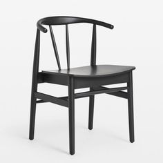 a black wooden chair on a white background with the seat up and back turned down