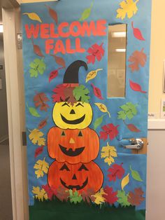 a door decorated with pumpkins and leaves