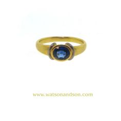 This gorgeous two-tone setting, 18k yellow gold and platinum, adds a modern flair to a traditional ring. This is an easy ring to wear because you can mix and match your yellow gold and white metal jewelry to further accessorize. Ring : 18k yellow gold and platinum ring featuring a faceted oval sapphire that is bezel set horizontally in a tapered band. Sapphire : Oval cut sapphire = 0.75 cts apx Color: Medium Blue Clarity : Eye Clean Circa : 1980  Size : 6.75  Stamped : 750  Gross Weight : 2.7 dwt Modern Yellow Gold Sapphire Ring With Center Stone, Gold Sapphire Ring With Oval Tension Setting, Gold Sapphire Ring With Tension Setting And Oval Shape, Modern Gold Sapphire Ring With Center Stone, Modern Yellow Gold Sapphire Ring With Round Cut, Elegant Oval Sapphire Ring With Smooth Bezel, Gold Sapphire Ring With Smooth Bezel For Anniversary, Modern Yellow Gold Sapphire Ring With Polished Finish, Classic Oval Sapphire Ring With Tension Setting