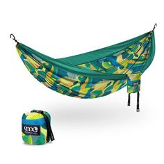 a green and yellow hammock sitting next to a bag