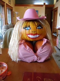 a large pumpkin sitting on top of a wooden table