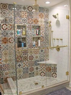 a bathroom with tiled walls and flooring in the shower area, including a glass door