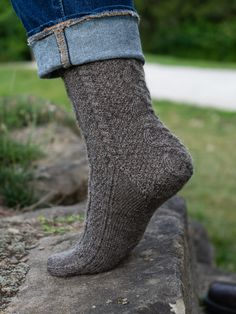 This top-down, richly-textured sock in two sizes S(L) is a gorgeous accessory for men and women alike. Worked in a warm, wooly yarn it is a hiking/rowing/snowshoeing essential; in sleek, smooth yarn it is a stylish accent to casual suits or slacks. With cabled details on all sides and cushy moss stitch panels, it is fun to work and a small project to be proud of—plus, a gift that says you think the most of a special someone. Shown here is size S in Border Leicester Fingering, color Rainbow GrayS Comfortable Knitted Socks For Fall, Casual Winter Hiking Socks, Casual Hiking Socks For Winter, Casual Knit Winter Socks, Winter Outdoor Fitted Socks, Fitted Winter Outdoor Socks, Casual Fitted Socks For Outdoor, Blanket Cardigan, Fluffy Socks