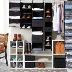 an organized closet with clothes and shoes hanging on the wall next to a wicker chair