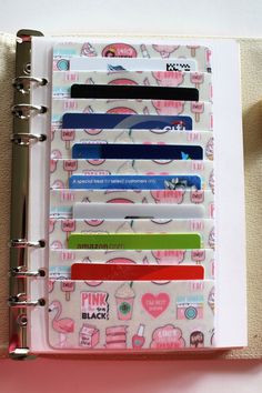 a binder with different types of stickers on it and a pen in the middle