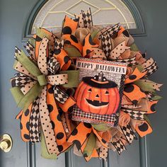 a halloween wreath with an image of a pumpkin on it