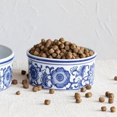 two blue and white bowls filled with dog food