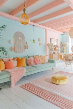 a living room filled with lots of furniture and colorful pillows on top of the couch