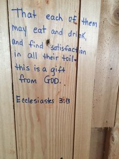 a piece of wood that has some writing on it with words written in blue ink