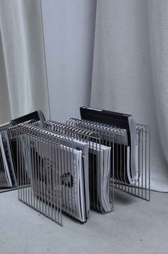 several binders stacked on top of each other in front of a window with curtains behind them