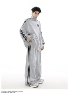 The "Urban Edge Athleisure Set" offers a stylish blend of comfort and street style. Featuring a soft grey zip-up jacket with a subtle chest emblem and matching drawstring pants with sleek side stripes. This tracksuit is perfect for versatile, everyday wear. Gray Winter Tracksuit Sportswear, Gray Long Sleeve Tracksuit For Leisure, Athleisure Activewear With Three Stripes For Lounging, Gray Tracksuit For Winter Streetwear, Gray Winter Tracksuit For Streetwear, Gray Long Sleeve Tracksuit With Ribbed Cuffs, Athletic Heather Sweats For Streetwear, Athletic Heather Sporty Sweats For Streetwear, Sporty Athletic Heather Sweats For Streetwear