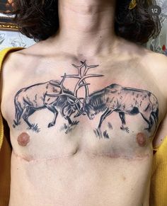 a man with tattoos on his chest has two cows and a cross drawn on it