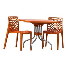 an orange table and two chairs sitting next to each other