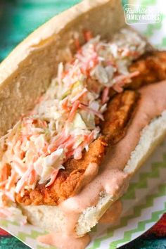 a hot dog with coleslaw and mayonnaise on it