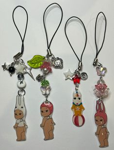 four necklaces with cartoon characters on them