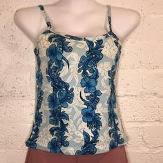 Cute Little Tank Top With A Few Problems In The Form Of Light Stains. Looks Like Discoloration Due To Aging But It Is Barely Noticeable Due To The Floral Designs And Colors. Priced Accordingly. See Pictures. Size Runs Small With 2-4” Of Stretch. 100% Cotton. Fine For A Beach Or Workout Top. Pit To Put 15.5” Hem Width 15.5” Length 14.5” From Front Neck To Hem Hawaii Tank Top, Blue Hawaiian Beach Top, Blue Hawaiian Tops For Beach Season, Blue Tropical Print Tops For Beachwear, Blue Hawaiian Printed Tops, Blue Hibiscus Print Top For Beach, Blue Hibiscus Print Beach Top, Blue Hibiscus Print Top For Spring, Blue Printed Beachwear Top