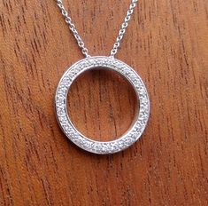 "This circle pendant is 16.75 mm wide made in 18k white gold set with natural VS clarity range diamonds 1/4 cts total weight. The 16 inch 1mm cable chain is 14k white gold and included. Pendant and chain total weight is aprox. 3 grams. . We love this pendant because it represents the way jewelry should be made with craftsmanship and quality. This pendant is anything but ordinary. Our pieces are designed and made with craftsmanship and sustainability in mind, our designs are made with handpicked Classic White Gold Jewelry For Anniversary Gift, Polished Round Jewelry For Anniversary Gift, Polished Finish Jewelry For Anniversary Gift, Anniversary Gift Jewelry With Polished Finish, Round Diamond Cut Jewelry For Anniversary, Round Diamond Cut Jewelry For Anniversary Gift, Classic Jewelry With Polished Finish For Anniversary, Classic Polished Jewelry For Anniversary Gift, Classic Jewelry With Polished Finish For Anniversary Gift