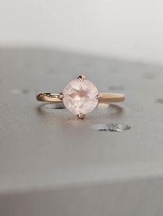 a pink ring sitting on top of a table