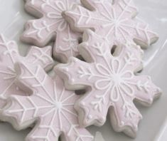 snowflake cookies on a plate with frosting