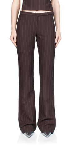 For a sleek and stylish look, choose the Jade Straight Leg Pants from BEC + BRIDGE. Crafted from a luxe plum pinstripe fabric, these pants sit on the mid-low waist with a slightly flared silhouette and two back welt pockets. A metal buckle at the waist edge binding completes the look. Perfect for pairing with the Jade Asymmetric Top for a modern outfit. ﻿Details: Color: Plum Pinstripe Main: 74% polyester, 21% viscose, 5% elastane; Lining: 95% polyester, 5% elastane Zip closure Mid-low rise, slig Brown Pinstripe Pants Outfit, Pinstripe Pants Outfit, Pinstripe Fabric, Asymmetric Top, Corporate Fashion, Bec Bridge, Pinstripe Pants, Bec & Bridge, Straight Trousers