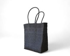 This Black Mexican artisan tote is a one-of-a-kind, handmade shoulder bag that combines elegance and traditional craftsmanship. Exclusive Artisan Craftsmanship: Handwoven by skilled artisans—only one piece available. Elegant Black Design: A classic black tote that pairs effortlessly with any outfit. Open-Top for Easy Access: Reach essentials quickly without closures or zippers. Comfortable Long Handles: Designed for convenient over-the-shoulder wear. Multi-Purpose Use: Perfect for shopping, office, beach outings, or daily adventures. Durable & Easy to Clean: Maintains shape, lightweight, and easy to keep looking fresh. Dimensions: 14 x 7 x 15 inchesColor: Black Traditional Black Rectangular Bag, Traditional Black Rectangular Shoulder Bag, Traditional Black Tote Bag, Traditional Black Tote Shoulder Bag, Traditional Black Shoulder Bag As Gift, Traditional Black Shoulder Bag Gift, Traditional Black Shoulder Bag For Gift, Traditional Black Bag For Everyday Use, Elegant Rectangular Bags For Market