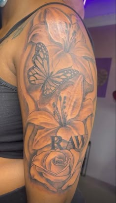 a woman's arm with flowers and butterflies on it