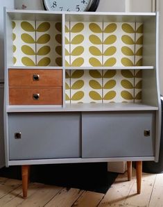 a dresser with drawers and a clock on top