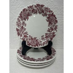 four red and white plates stacked on top of each other