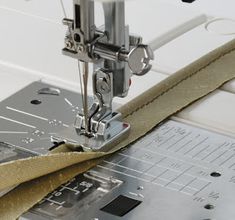 the sewing machine is being used to sew fabric on it's sides,