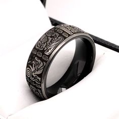 Exchange vows on your wedding day with this exclusive Custom Black Tungsten Ring with Ancient Aztec Symbols. The ring measures 8mm in width and is available from sizes 5 to 15. If you would like a matching ring in 6mm, please contact us. The ring is designed with a comfort fit interior. - Width - 8mm - Material - Tungsten Carbide - Color - Black, Silver - Sizes - 5 to 15 - Finish- High Polished Interior, Matte Exterior - Free Laser Engraving - Free Gift Box - Hypoallergenic To see more ring desi Gothic Oxidized Finish Rings For Gift, Aztec Jewelry Men, Symbolic Black Rings With Oxidized Finish, Aztec Ring Men, Mayan Jewelry Men, Aztec Symbols, Ancient Aztecs, Black Tungsten Rings, Tungsten Mens Rings